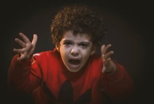 A young child expressing strong emotions during a studio portrait shoot treated by dr rameez shaikh